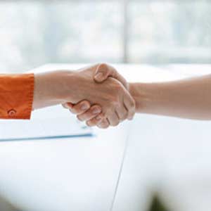 Person shaking hands, representing a mentoring program